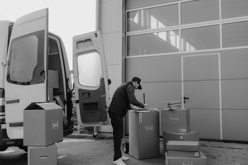 Movers carefully loading protected furniture into a moving truck