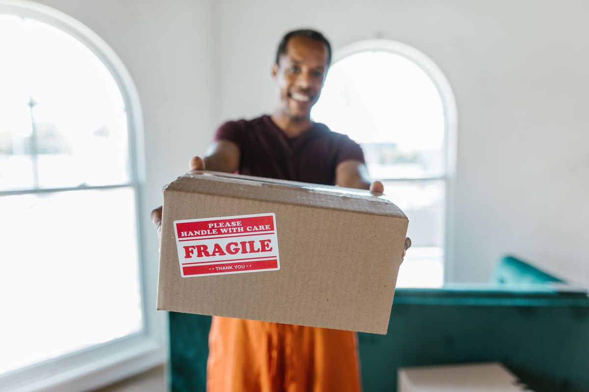 Teamwork Moving professionals moving apartment boxes toward an elevator in Phoenix