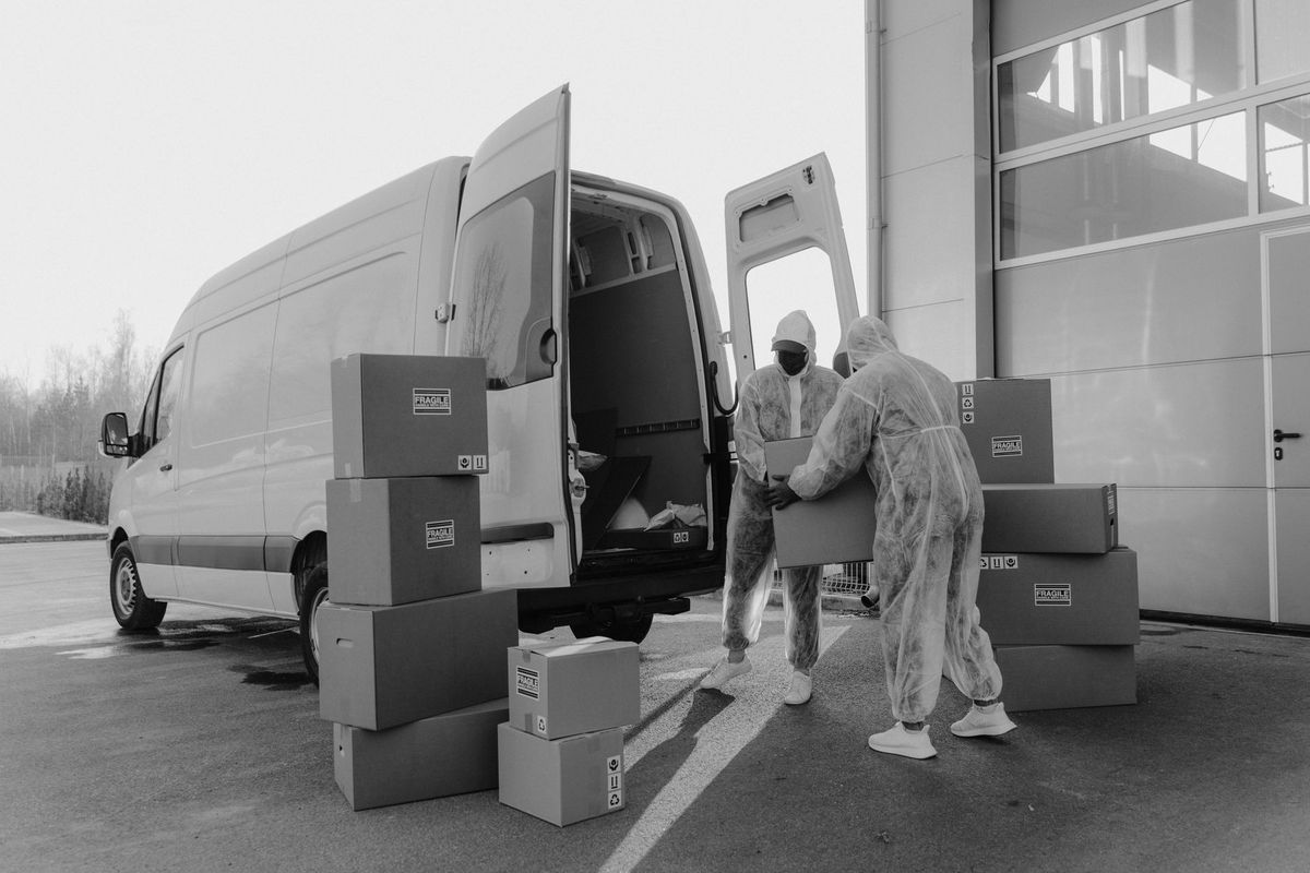 Teamwork Moving crew carefully loading household boxes into a moving truck in Phoenix